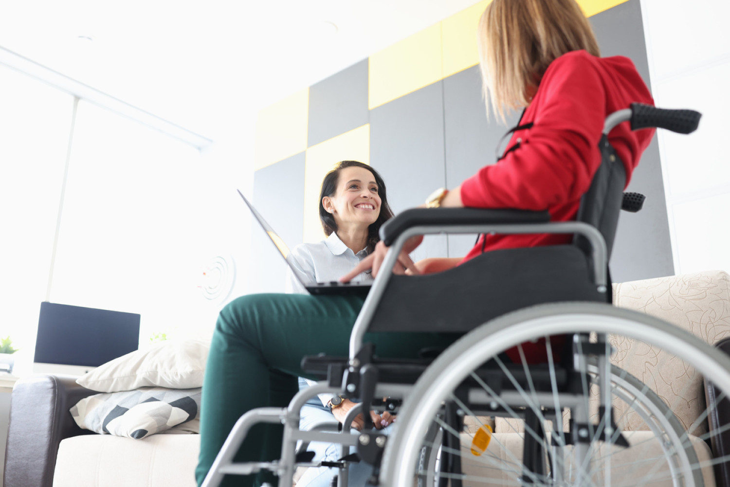 A one-on-one session with a student in a wheelchair, showcasing the provision of tailored educational support for students with physical disabilities.